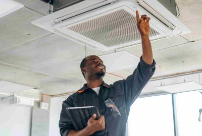 with-hands-high-up-fixing-ventilation-repairman-is-indoors-modern-office_11zon